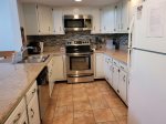 Fully equipped kitchen with cookware, flatware, utensils, microwave, dishwasher, and standard 12 cup coffee maker